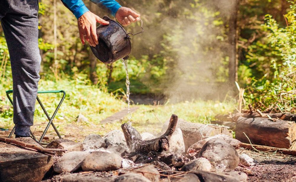 A person extinguishing a campfire.